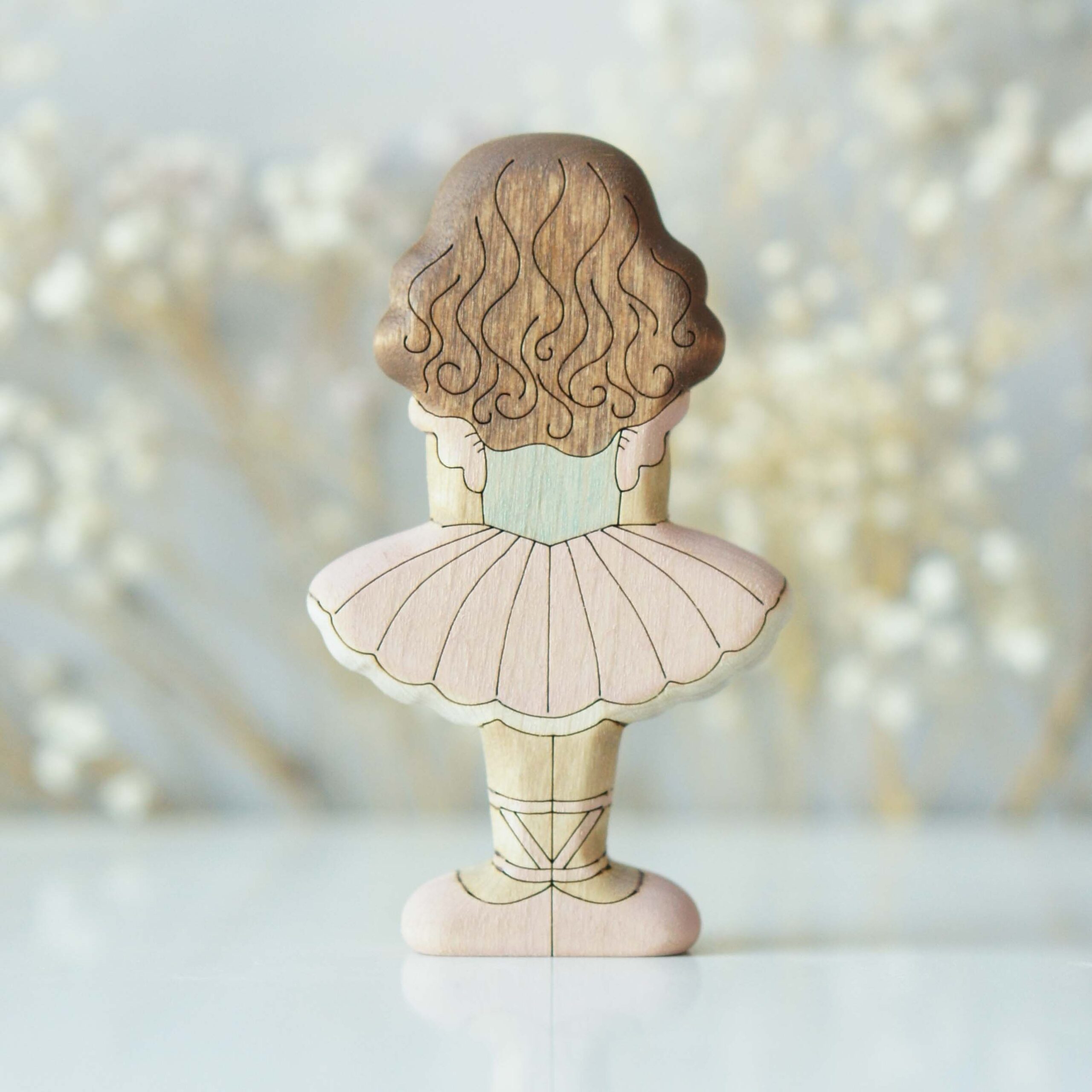 Brunette ballerina in pink - back view
