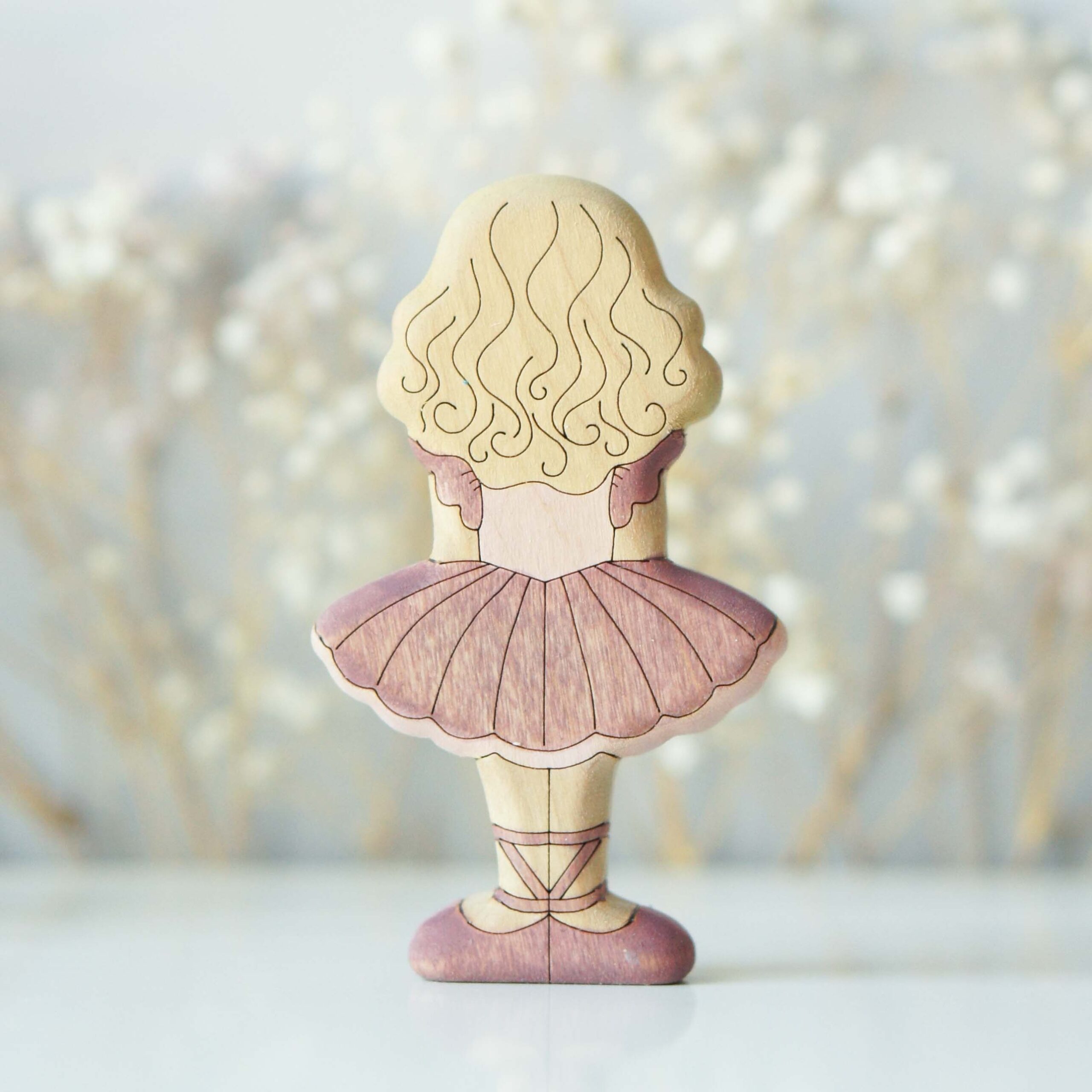 Blonde ballerina in plum - back view