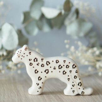 Wooden snow leopard toy with sparkle